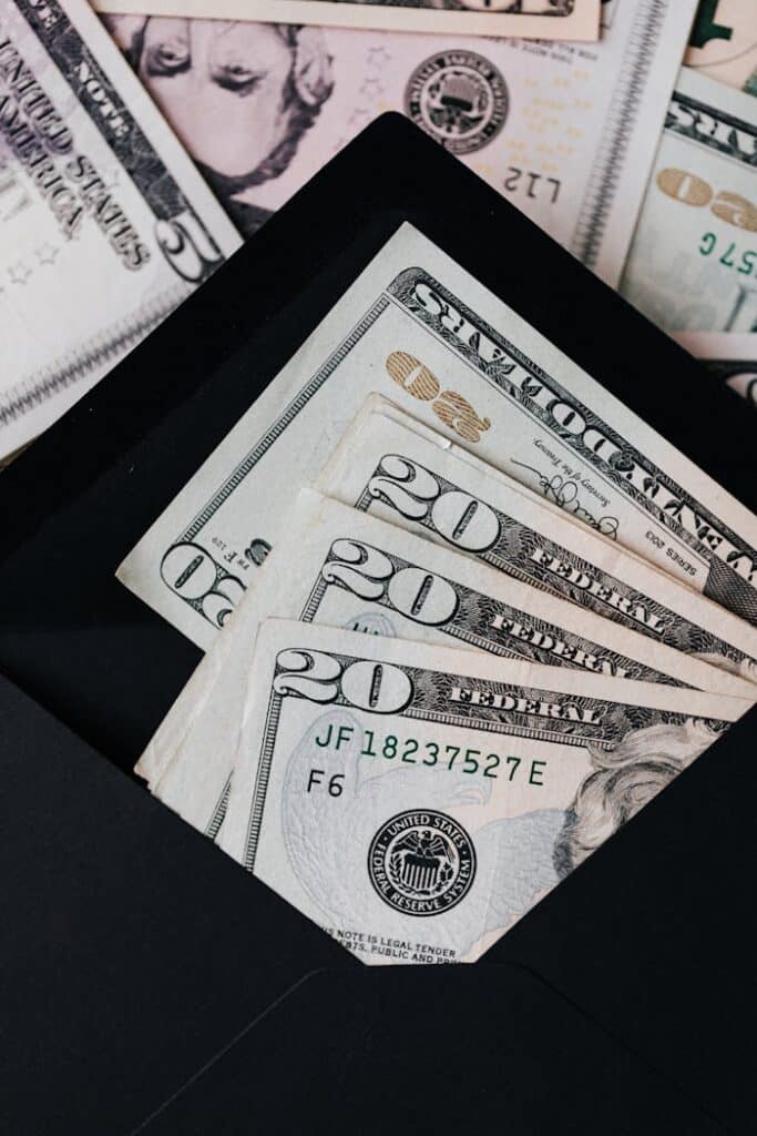 stack-of-dollars-and-black-envelope-with-banknotes-inside-4386365 Stack of dollars and black envelope with banknotes inside
